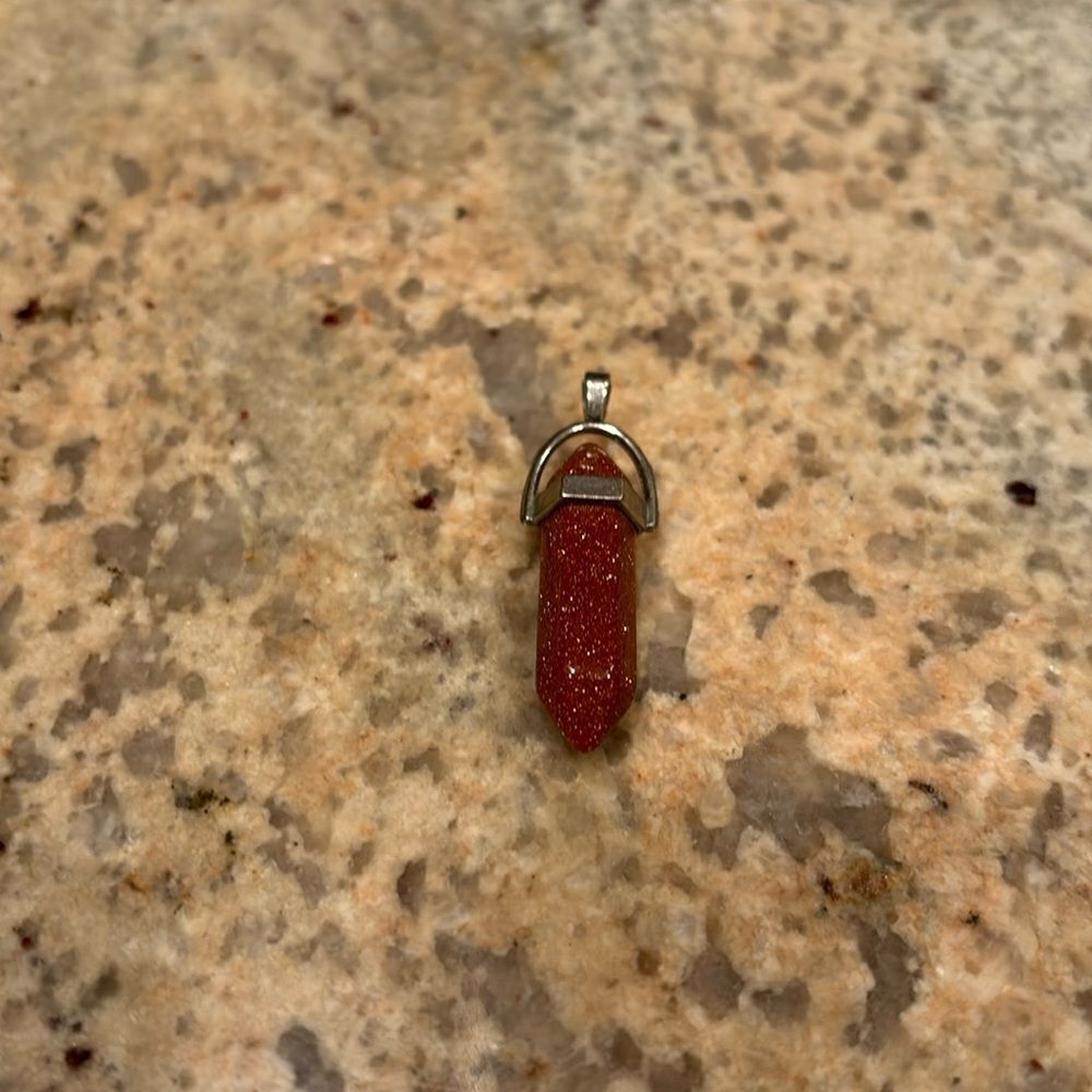 Crystal Gold Sand stone. It's only the crystal no necklace